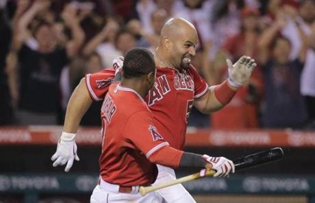 Angels infielder Albert Pujols (right) celebrated with teammate Erick Aybar after Pujols? game-winning home run in the 19th inning.
