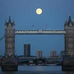 The supermoon rose over Tower Bridge in London Sunday.