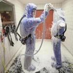 A nurse and a doctor demonstrated the decontamination procedure at a hospital in Berlin, Germany.
