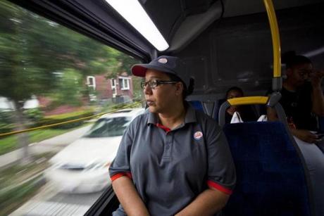 Enid Lugo, 52, on the bus this week to her fast-food job in Holyoke, says she gets no paid vacation time.
