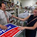 State GOP chairwoman Kirsten Hughes met with Tuan Tran, owner of Kim Pharmacy, during a tour of Fields Corner Tuesday.