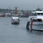 The Provincetown IV, right, was escorted into port by Coast Guard vessels.