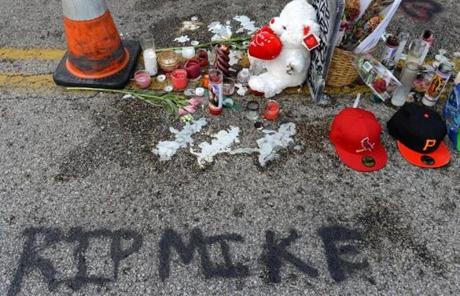 Several items mark the location where Michael Brown was killed.

