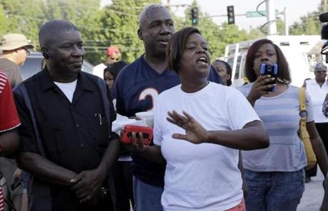 People reacted after officer Darren Wilson's name was released in Ferguson, Mo.
