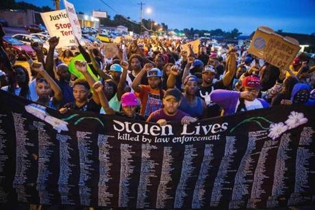 Protesters marched in Ferguson, Mo., Saturday against last week?s fatal police shooting of an unarmed black teenager.
