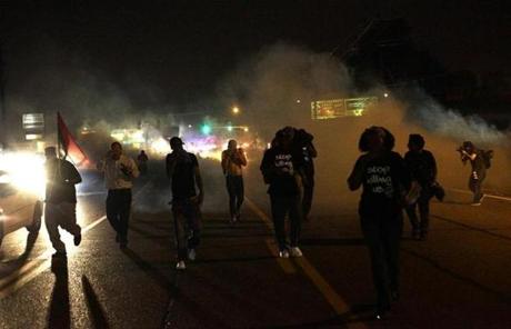 Tear gas and smoke returned to the streets of Ferguson despite calls for peace earlier Sunday in the St. Louis suburb.
