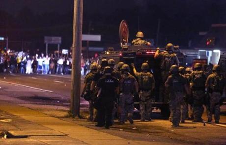 Police advanced on a group of protesters in Ferguson, Mo., late Sunday.
