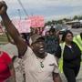 Protesters marched down West Florissant Avenue in Ferguson, Mo., and clashes between police and protesters continued.