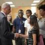 Attorney General Eric Holder shook hands with Bri Ehsan, 25, after meeting with students at St. Louis Community College Florissant Valley in Ferguson, Mo., on Wednesday.