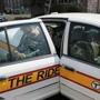 A passenger leaves a vehicle used by the MBTA?s The Ride service.