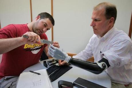 Ioannis Smanis measured Mike Benning?s prosthetic arm.
