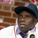 Outfielder Rusney Castillo talks with reporters following his official signing with the Red Sox to a seven-year contract Saturday. (Michael Dwyer/Associated Press)