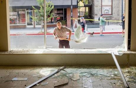 Juan Becerra cleaned up broken glass at a vacant store in Napa, Calif.
