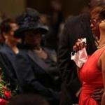 Lesley McSpadden, the mother of Michael Brown, the unarmed black teen who was shot and killed by a white police officer, was comforted during his funeral service Monday in St. Louis. Thousands of people attended the event, with some speakers imploring mourners to work for justice for Brown and for others.