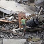 A Palestinian climbed through the rubble of a house after it was hit in an Israeli air strike in Gaza City on Monday.
