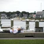 Laura Smales of Toronto relaxed along the wall overlooking Hyannis Harbor on Sunday.