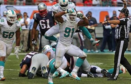 Cameron Wake celebrated his fouth-quarter sack of Brady, forcing a fumble that the Dolphins recovered.

