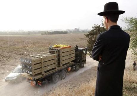 An ultra-Orthodox Jewish man watched as a truck transported Iron Dome anti-missile batteries in the southern city of Ashdod on Nov. 17, 2012.
