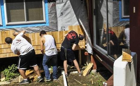 Members of Alpha Chi Alpha fraternity at Dartmouth College shingled a house for Habitat for Humanity.
