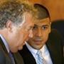 Aaron Hernandez spoke with his lawyer, Michael Fee, during a hearing in July.