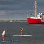 Stand-up paddle boarders move past Nantucket's Brant Point Lighthouse (not pictured). 