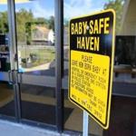 A baby-safe haven sign stands at the entrance to the Blackstone police station.