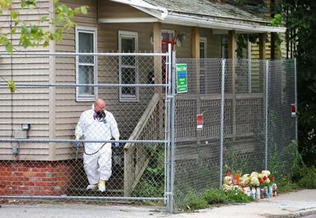 An exterminator sprayed at the home behind a fence that was put up Saturday.
