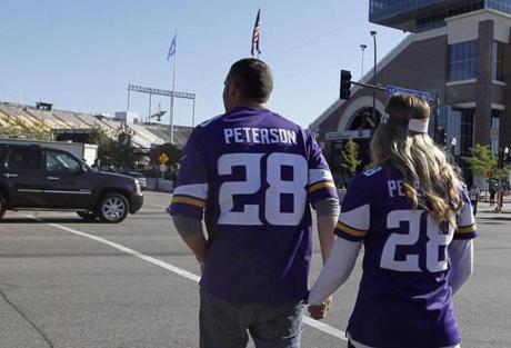 Vikings fans walk to TCF Bank Stadium wearing Adrian Peterson jerseys before the start of Sunday?s game.
