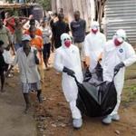 Health workers in Liberia removed the body of an Ebola victim. A Boston organization is sending staff to help in rural parts of the country. 