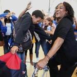 Dacia Evans (far left), Aaron Da Grasa (middle), and other students danced with Headmaster Lindsa McIntyre (right) after MCAS scores released the Jeremiah E Burke High School from underperforming status.