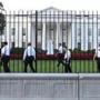Secret Service officers walked along the fence on the north side of the White House Saturday.