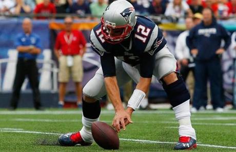 Tom Brady reached for the ball after a low snap late in the second quarter.
