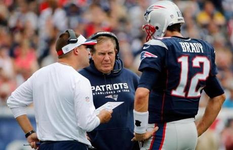 Josh McDaniels, Bill Belichick, and Tom Brady talked on the sideline in the first half.
