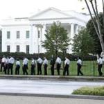 Secret Service officers walked along the fence on the north side of the White House Saturday. 