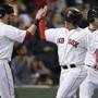 Christian Vazquez (center) is congratulated by Bryce Bentz after scoring with Daniel Nava (rear) on Xander Bogaerts?s single during the Sox? five-run fourth inning.  (Michael Dwyer/Associated Press)