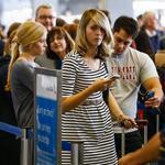 Passengers waited in long lines to check-in and re-book after flights were delayed or cancelled at O?Hare International Airport on Friday.