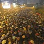 Pro-democracy protesters held umbrellas under heavy rain in a main street near the government headquarters in Hong Kong late Tuesday.