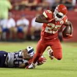 KANSAS CITY, MO - SEPTEMBER 29: Jamaal Charles #25 of the Kansas City Chiefs is tripped up by Logan Ryan #26 of the New England Patriots during the first quarter at Arrowhead Stadium on September 29, 2014 in Kansas City, Missouri. (Photo by Peter Aiken/Getty Images)