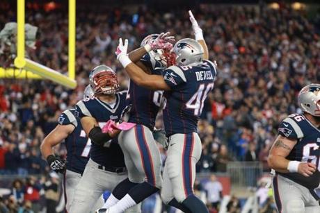 The Patriots celebrated Tim Wright's touchdown in the first quarter. (Jim Davis/Globe Staff)
