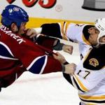 Milan Lucic mixes it up with Montreal?s Mike Komisarek. Globe Staff Photo / Barry Chin)