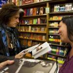 Joe Perry greets fan Marianne Dambra of Rochester, N.Y., at his book signing at Brookline Booksmith on Thursday.