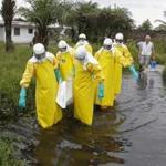 A Liberian burial squad carried the body of an Ebola victim in Marshall, Margini county, Liberia. 