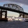 A New England Aquarium Whale Watch boat traveled under the Long Island Bridge. 