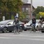 Bicyclists at the corner of Somerville Avenue and Beacon Street wait for the green light.