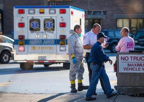 An ambulance sat in the parking lot outside the Harvard Vanguard Medical Associates building in Braintree where a possible case of Ebola was reported.
