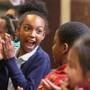 Aniah Mitchell and fellow fourth graders clapped after watching an anniversary film that recounted the Mather School's 375th birthday. 