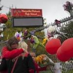 Members of the community and students grieved beside a makeshift memorial at Marysville-Pilchuck High School on Sunday. 