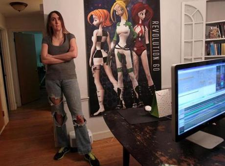 Brianna Wu with a poster of some of her video game characters.
