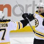 Patrice Bergeron celebrated an overtime goal by Brad Marchand against the Buffalo Sabres on Thursday. 