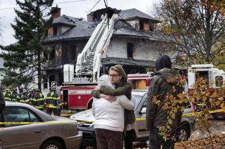 Friends of a victim of the fire consoled one another other Saturday in Portland, Maine.
